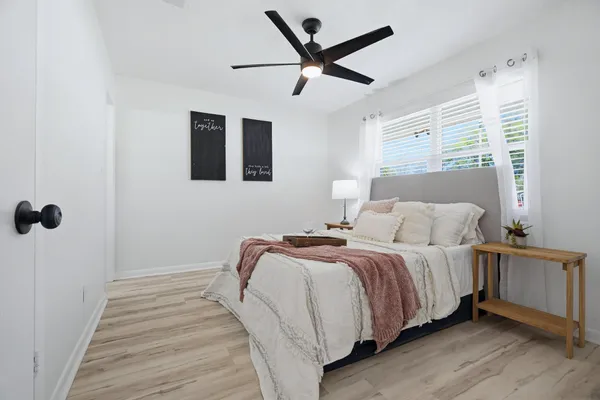 a bedroom with a bed and a lamp