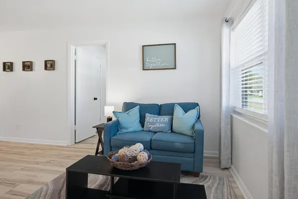 a living room with furniture and wooden floor