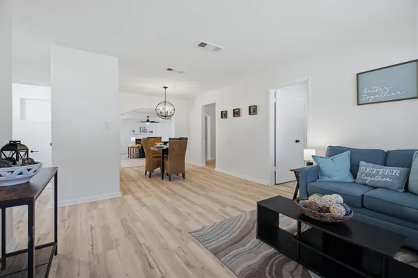 a living room with furniture and wooden floor