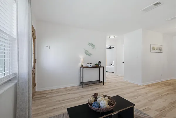 a living room with furniture and wooden floor