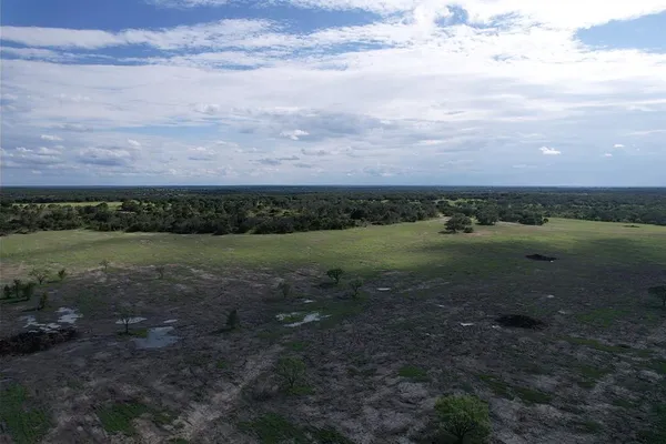 a view of a field with an ocean