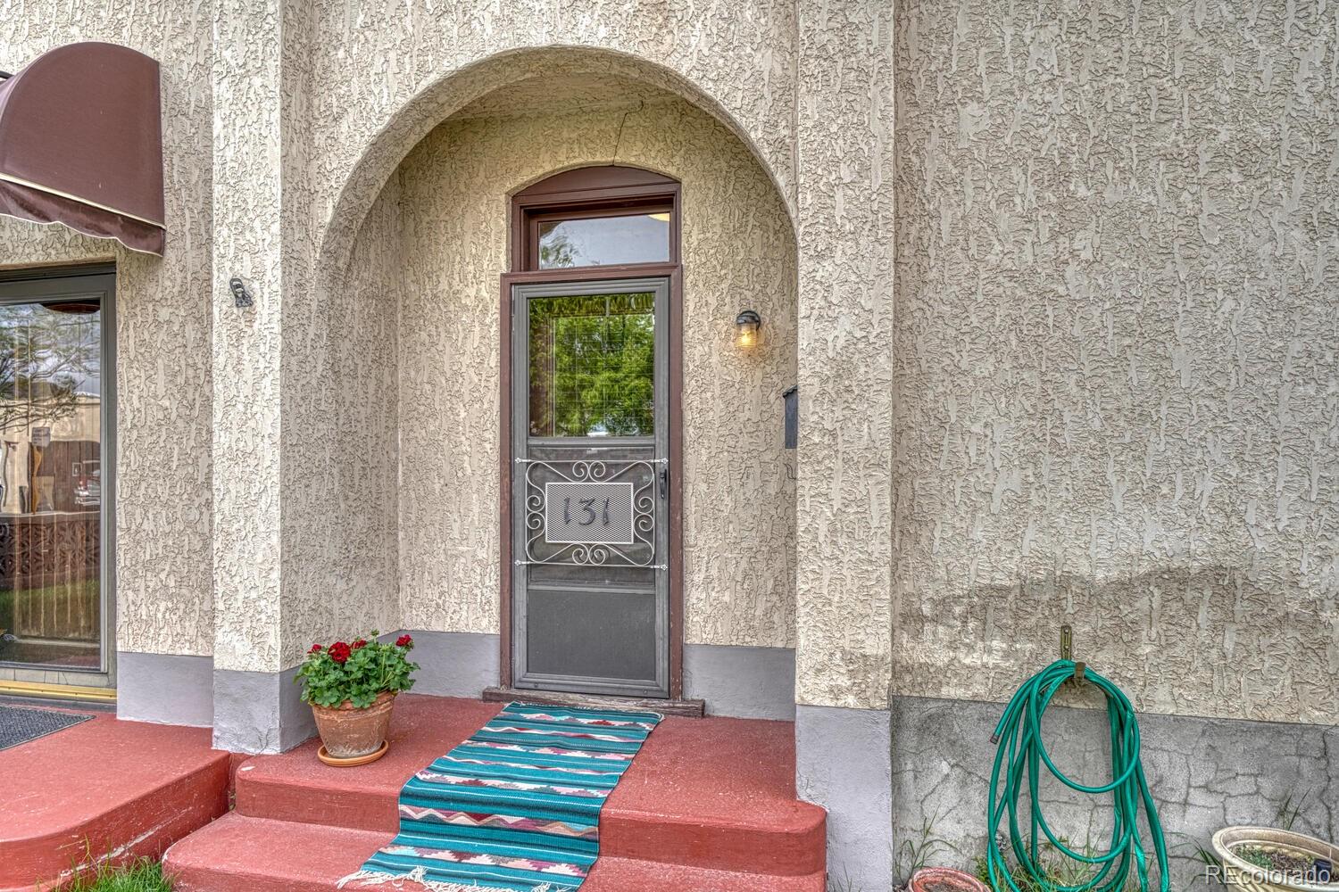 a front view of a house with outdoor seating