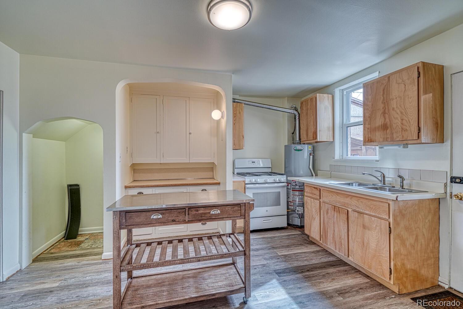 131 E Street Salida, CO 81201 - Photo 12 of 35 a kitchen with a stove a sink and a refrigerator