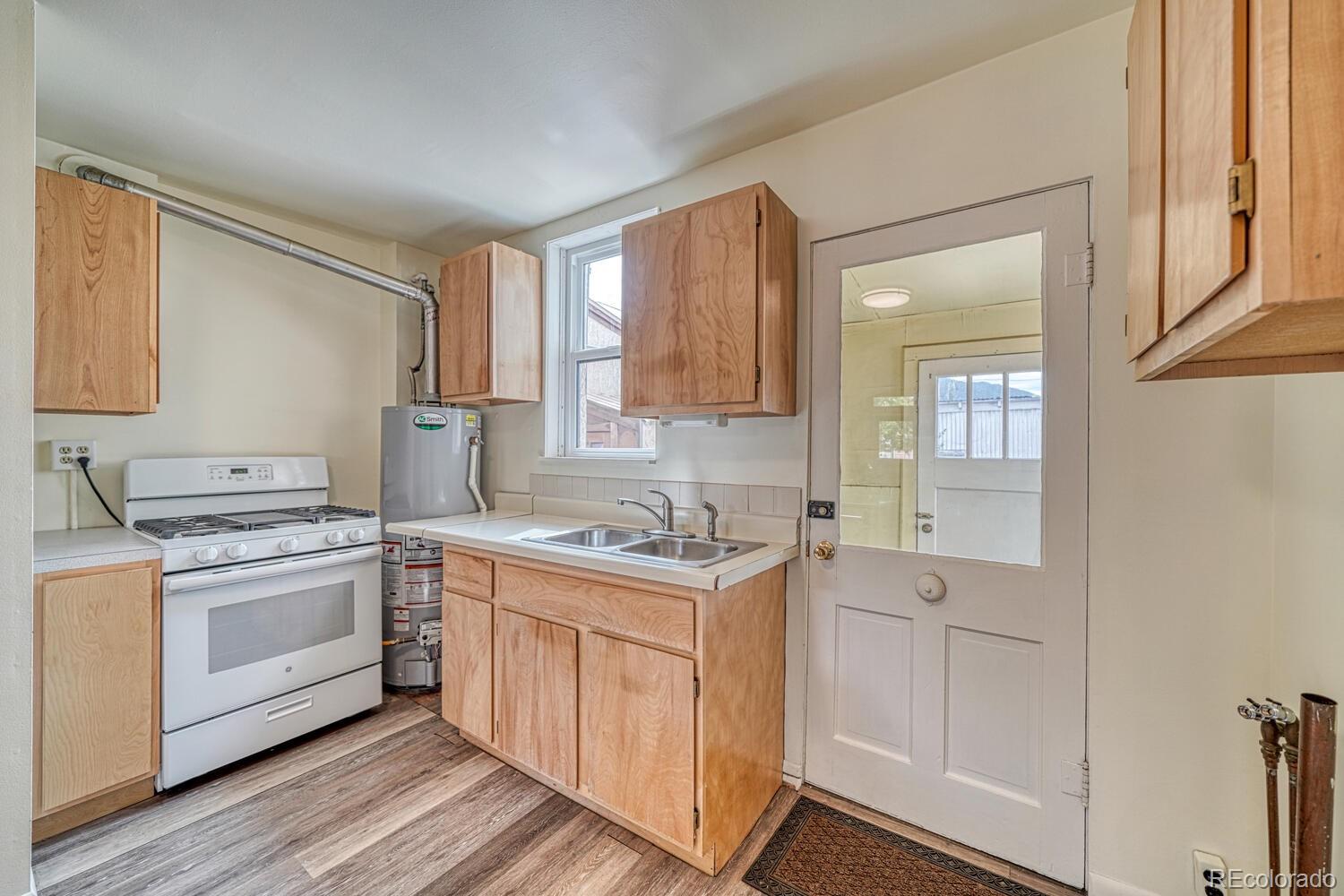 131 E Street Salida, CO 81201 - Photo 13 of 35 a kitchen with a stove top oven sink and cabinets