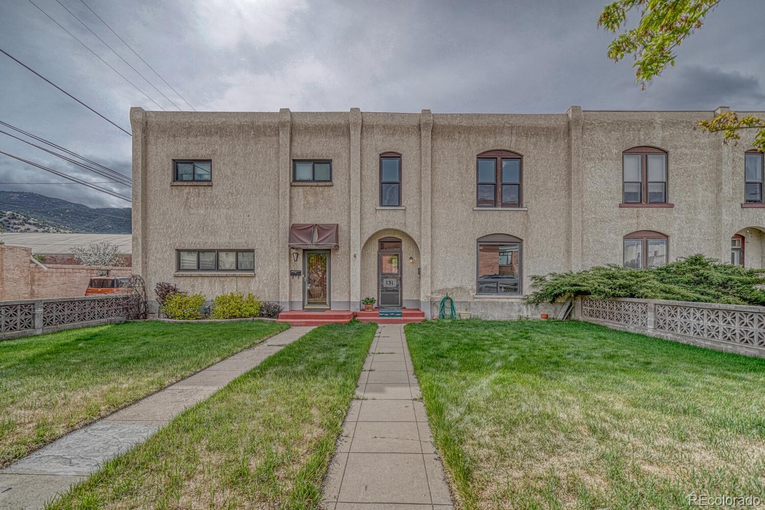 131 E Street Salida, CO 81201 - Photo 2 of 35 a front view of a building with garden