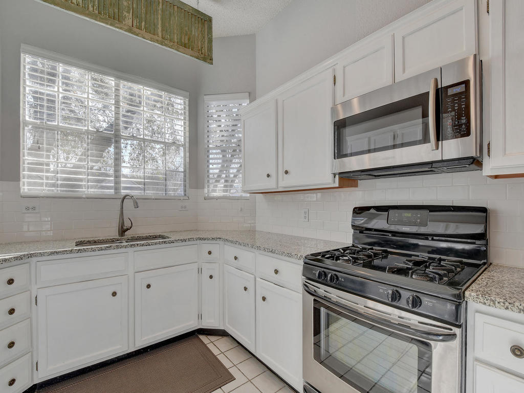 3019 Rochelle Drive Austin, TX 78748 - Photo 9 of 21 a kitchen with appliances a sink and cabinets