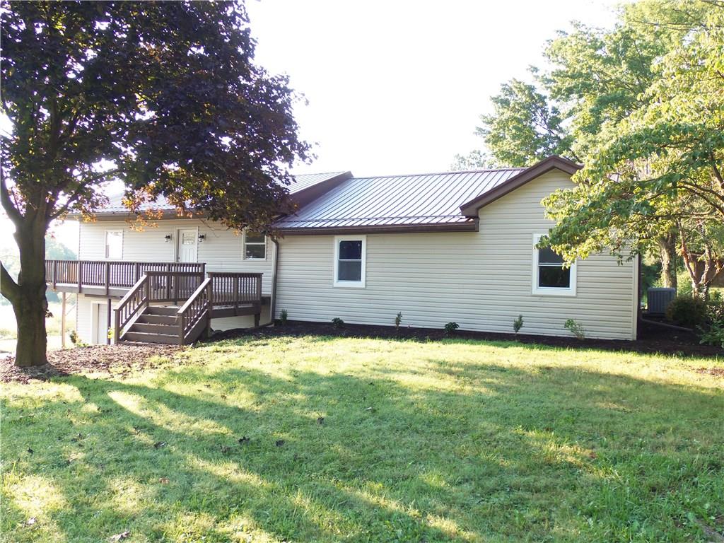 636 Wilson Mill Road New Castle, PA 16105 - Photo 2 of 18 a backyard of a house with yard and basket ball court