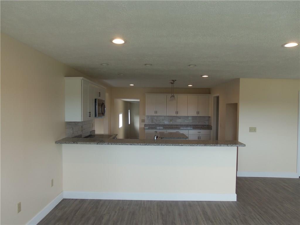 636 Wilson Mill Road New Castle, PA 16105 - Photo 11 of 18 a view of a kitchen with a sink and dishwasher a refrigerator with wooden floor