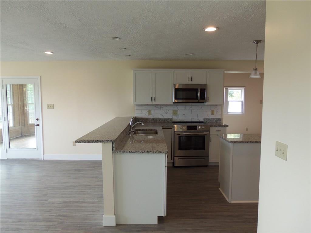 636 Wilson Mill Road New Castle, PA 16105 - Photo 12 of 18 a kitchen with a stove and a microwave