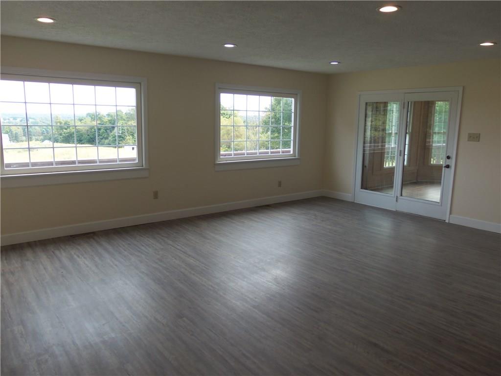 636 Wilson Mill Road New Castle, PA 16105 - Photo 13 of 18 an empty room with wooden floor and windows
