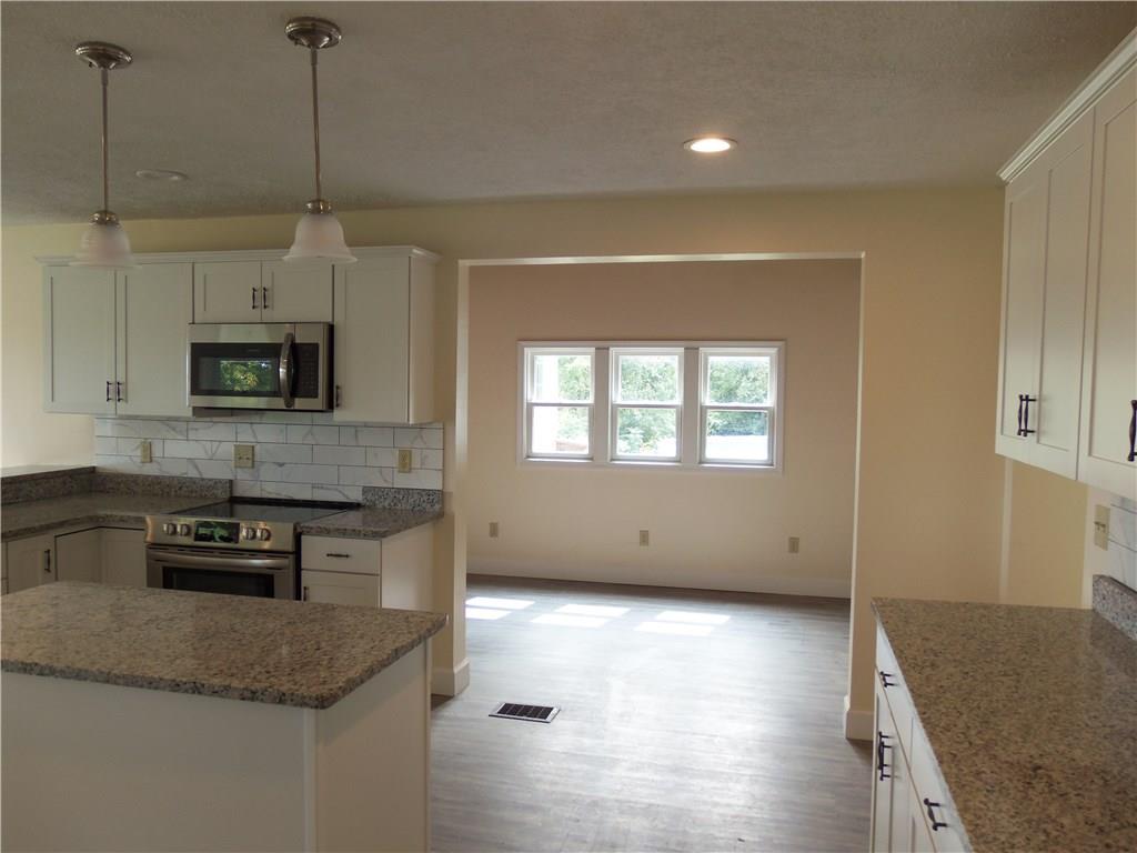 636 Wilson Mill Road New Castle, PA 16105 - Photo 10 of 18 a kitchen with stainless steel appliances granite countertop a stove a sink and a microwave