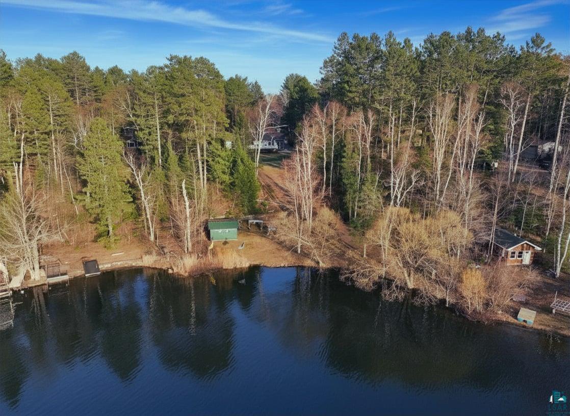 3975 Long Lake Shores Road Eveleth, MN 55734 - Photo 78 of 84 Lakefront property featuring extensive tree coverage, multiple docks, and two waterside structures