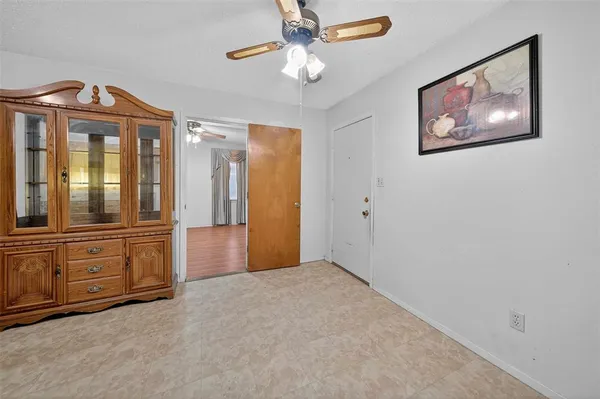 an empty room with closet and windows