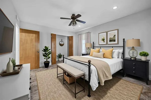 a bedroom with a bed and a flat screen tv