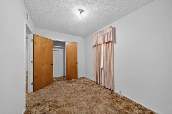 a view of a room with sliding door and wooden floor