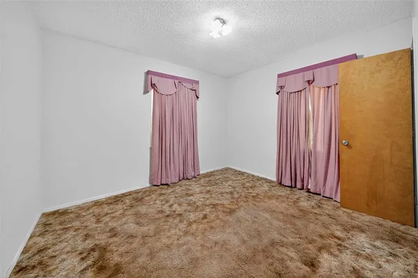a view of a room with a wooden door