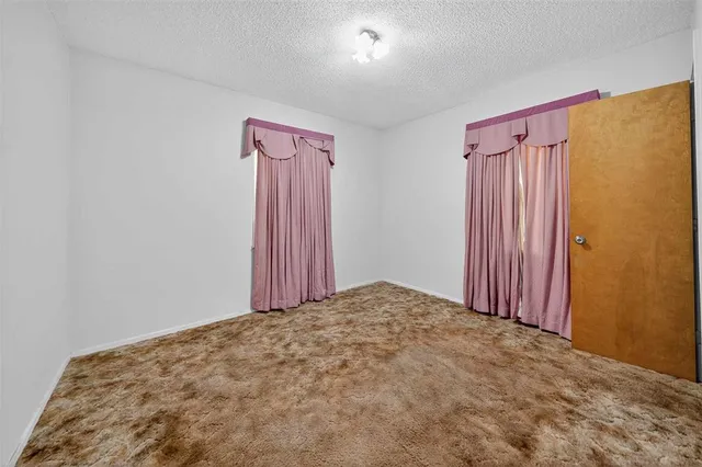a view of a room with a wooden door