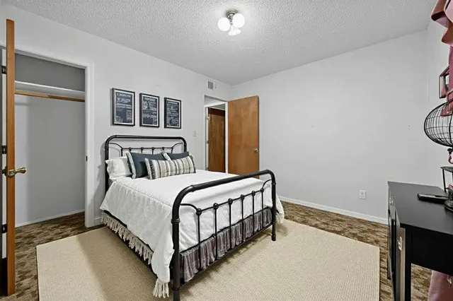 a bedroom with a bed and window