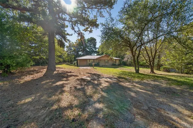 a view of a house with swimming pool and sitting area