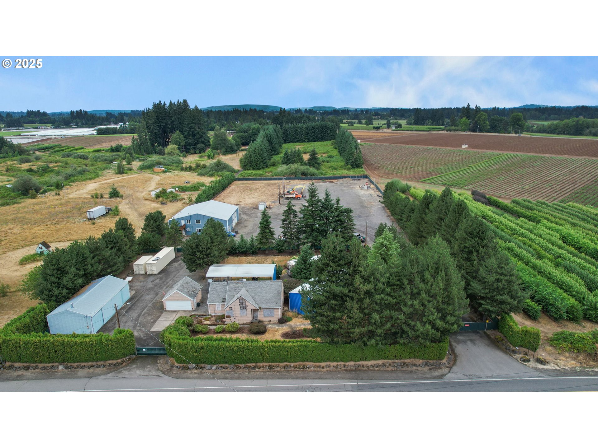 an aerial view of residential houses with outdoor space and lake view