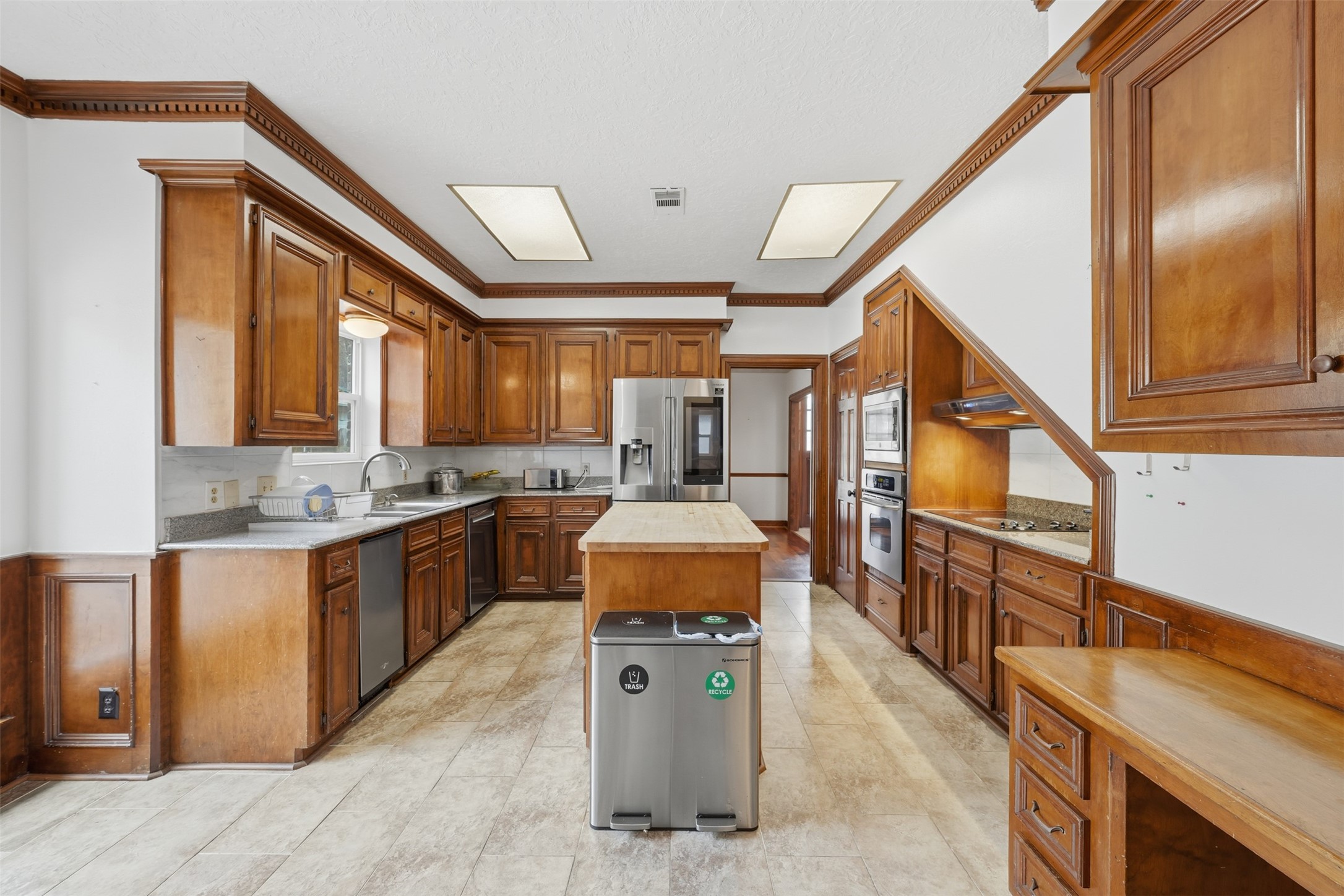 1422 Trace Drive Houston, TX 77077 - Photo 11 of 47 a large kitchen with stainless steel appliances granite countertop a sink and cabinets