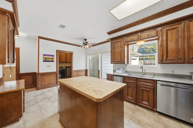 a kitchen with a stove a sink dishwasher and a refrigerator