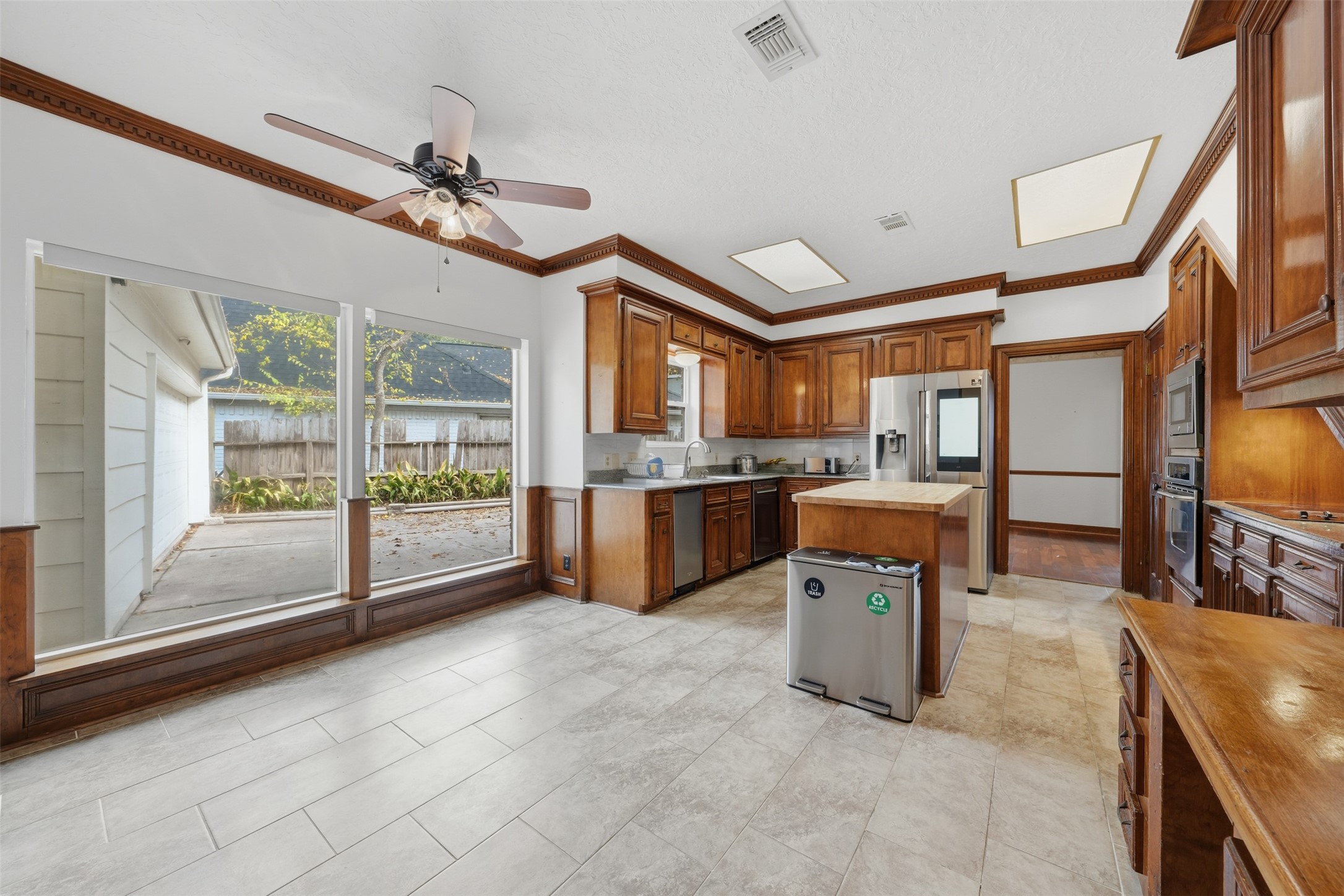 1422 Trace Drive Houston, TX 77077 - Photo 15 of 47 a view of a kitchen and dining area a chandelier fan windows