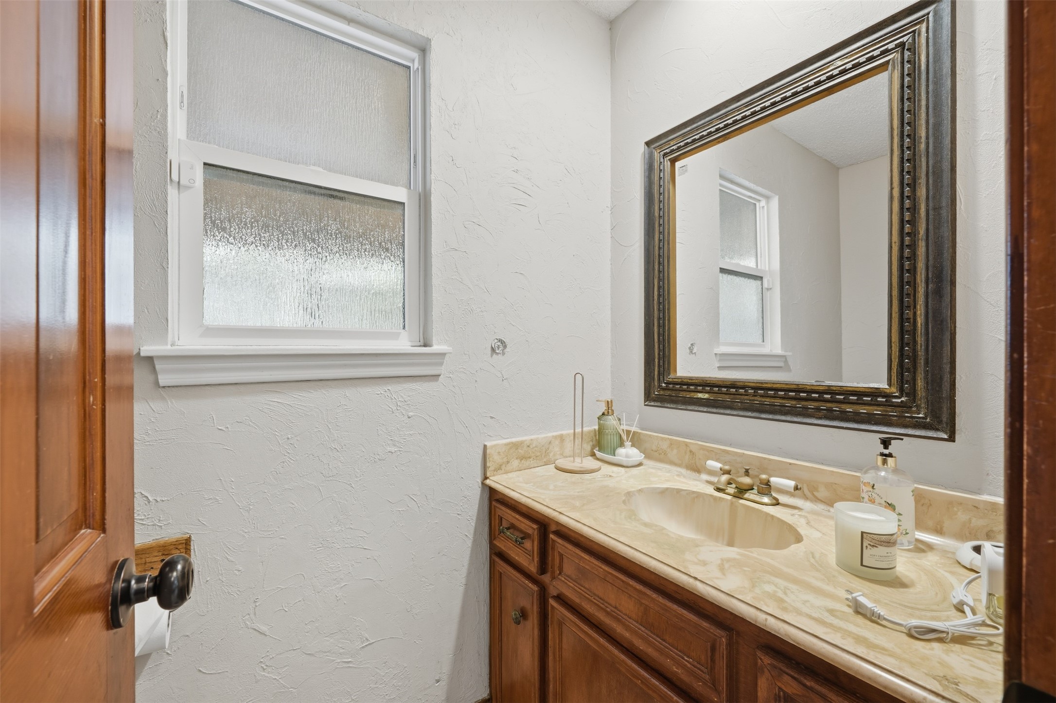 1422 Trace Drive Houston, TX 77077 - Photo 18 of 47 a bathroom with a sink vanity and mirror
