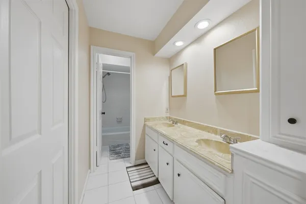 a bathroom with a bathtub shower and toilet