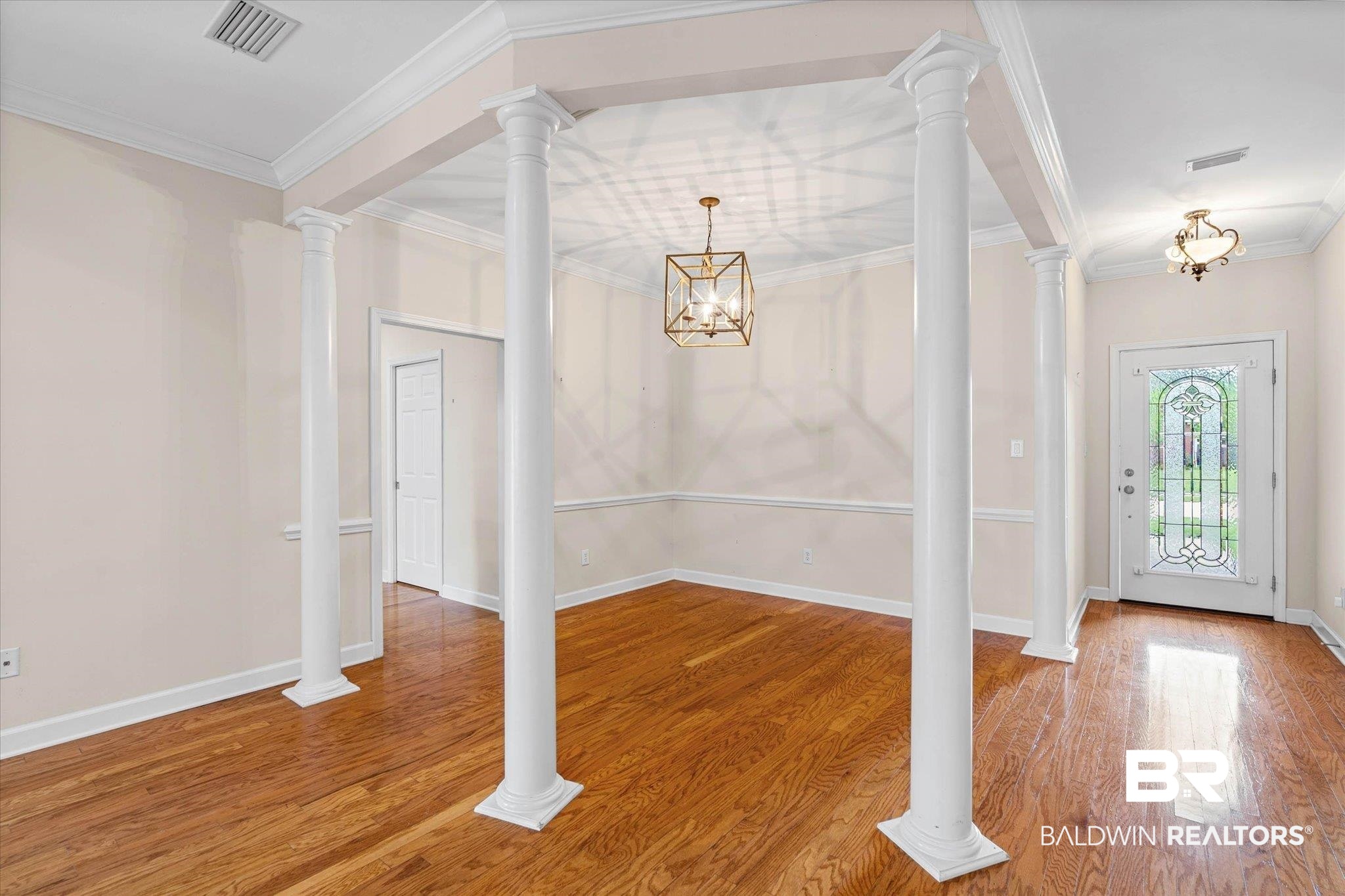 1003 Weatherby Street South Saraland, AL 36571 - Photo 8 of 31 Entrance foyer featuring ornate columns, hanging lights, crown molding, and light wood-style floors