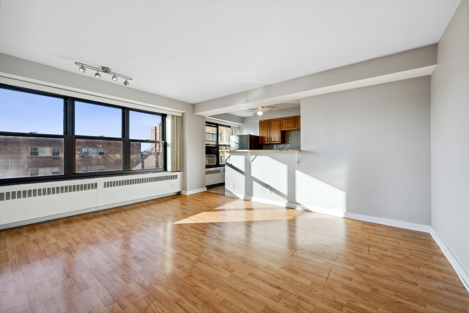 6118 North Sheridan Road, Unit 509 Chicago, IL 60660 - Photo 5 of 10 a view of an empty room with window and wooden floor