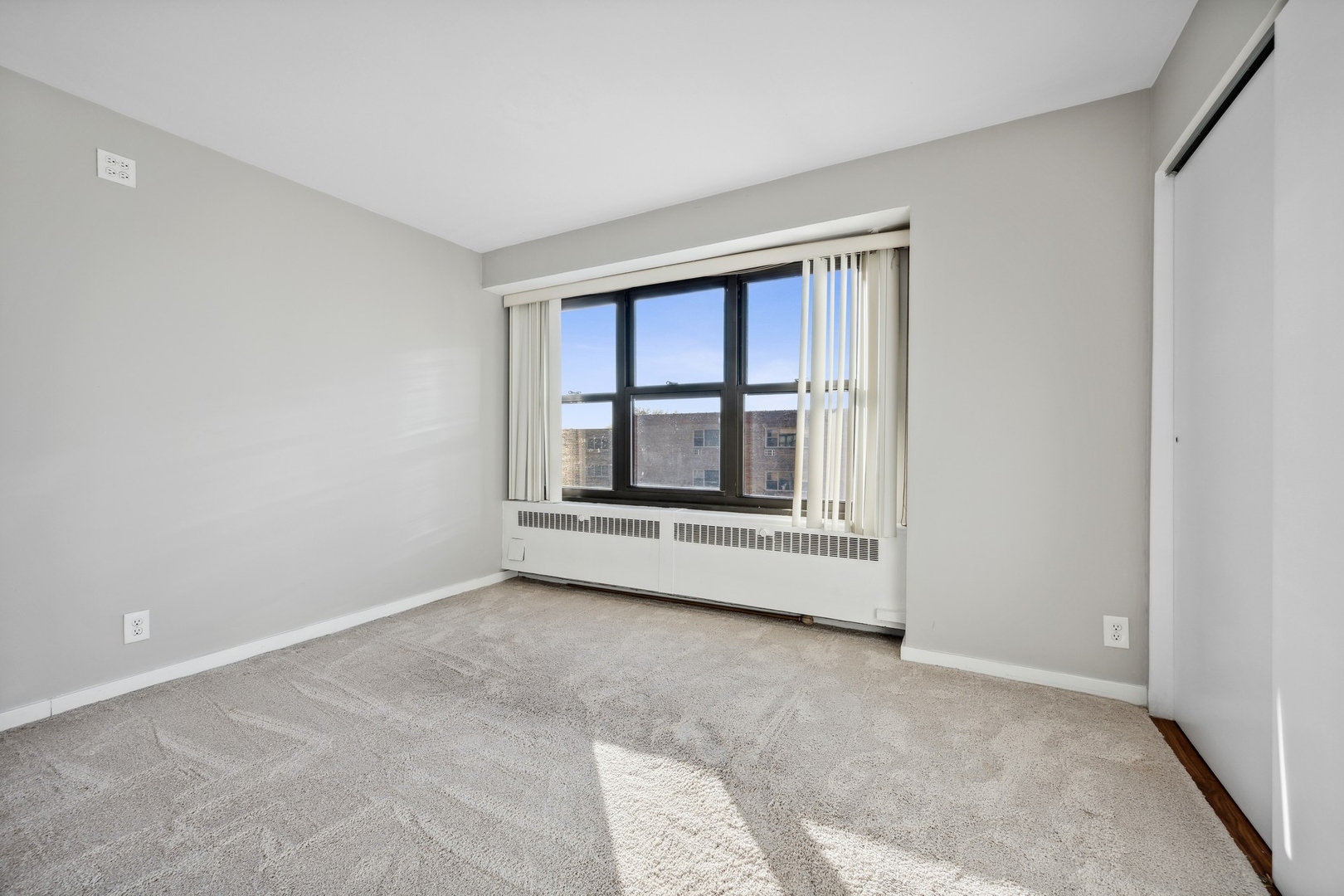 6118 North Sheridan Road, Unit 509 Chicago, IL 60660 - Photo 6 of 10 a view of an empty room with a window and fireplace