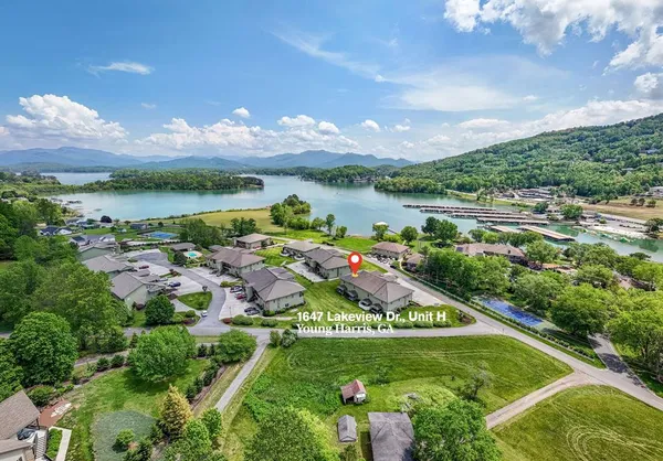 an empty room with wooden floor fireplace and window