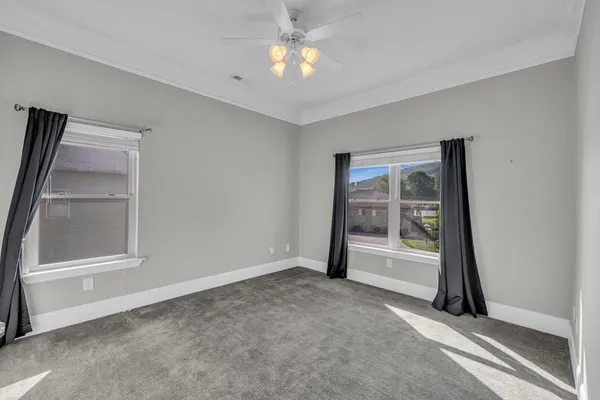 a kitchen with stainless steel appliances a table chairs refrigerator and microwave