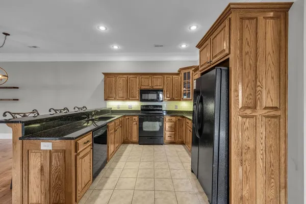 a kitchen with stainless steel appliances granite countertop a sink a microwave cabinets and a granite counter tops