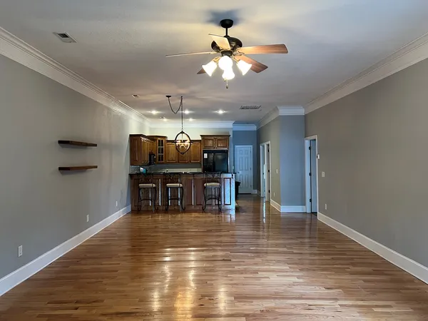 a view of a dining room with furniture and chandelier