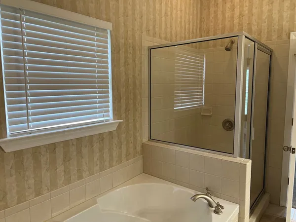 a bathroom with a shower and a window