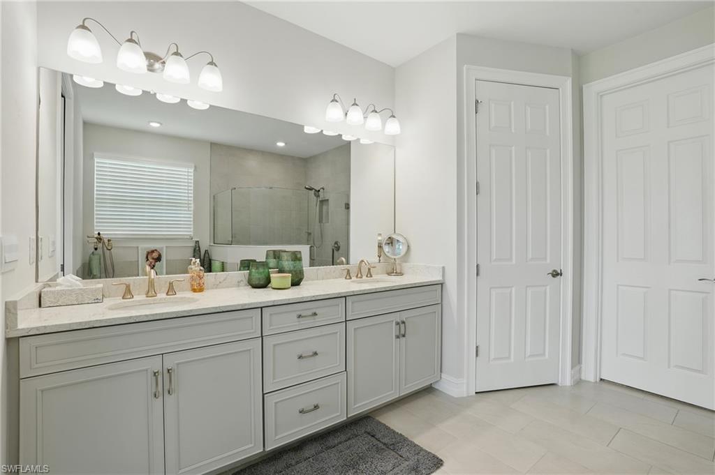 28165 Captiva Shell Loop Bonita Springs, FL 34135 - Photo 19 of 38 a bathroom with a double vanity sink and a mirror