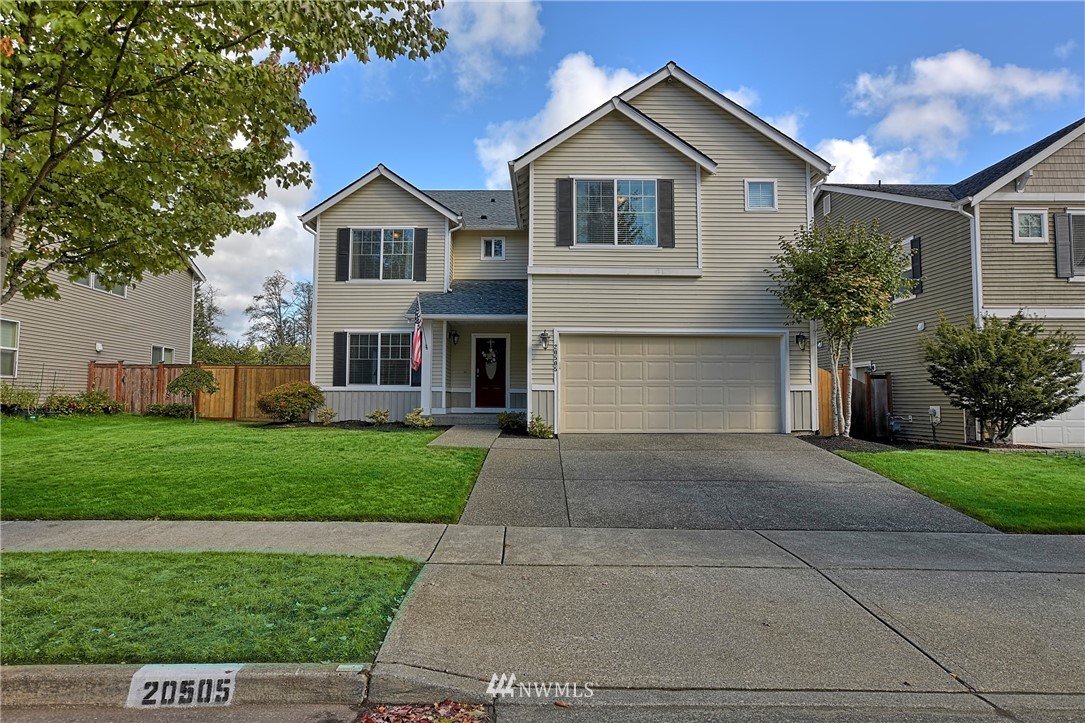 20505 Rustic View Road Southeast Monroe, WA 98272 - Photo 1 of 40 a front view of a house with a yard and garage