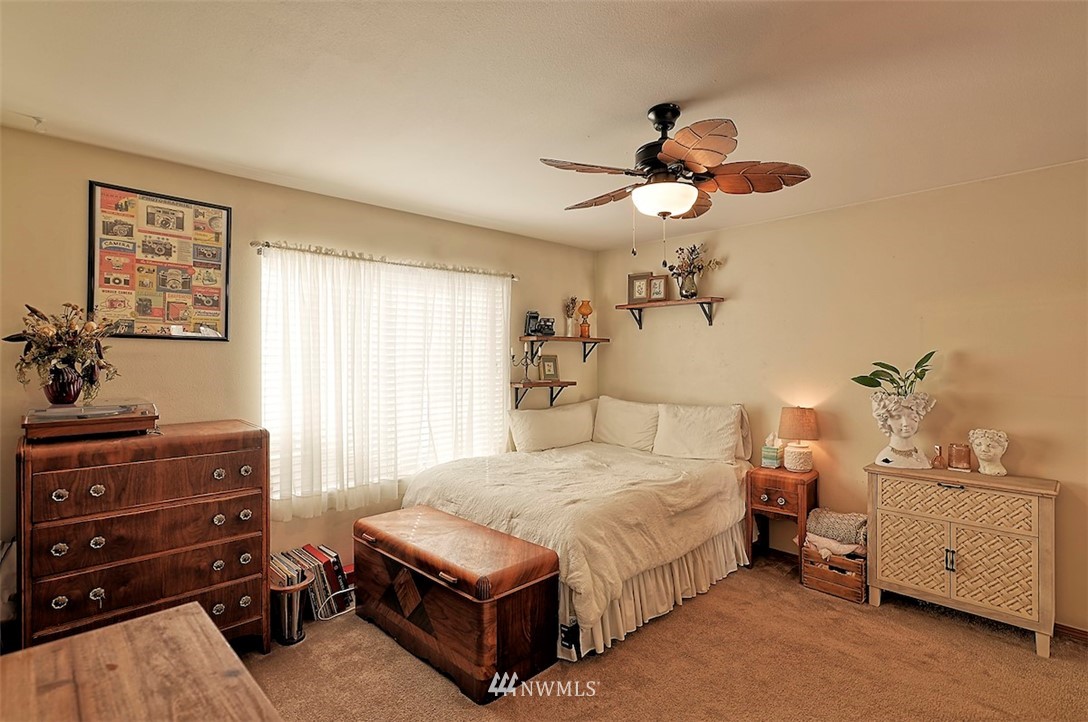 20505 Rustic View Road Southeast Monroe, WA 98272 - Photo 22 of 40 a bedroom with a bed and a chandelier