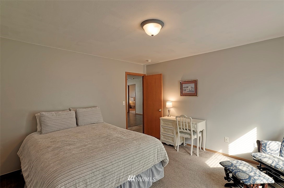 20505 Rustic View Road Southeast Monroe, WA 98272 - Photo 23 of 40 a bedroom with a bed and a chair
