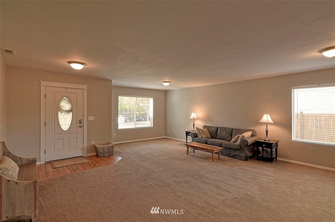 20505 Rustic View Road Southeast Monroe, WA 98272 - Photo 4 of 40 a living room with furniture a window and a lamp