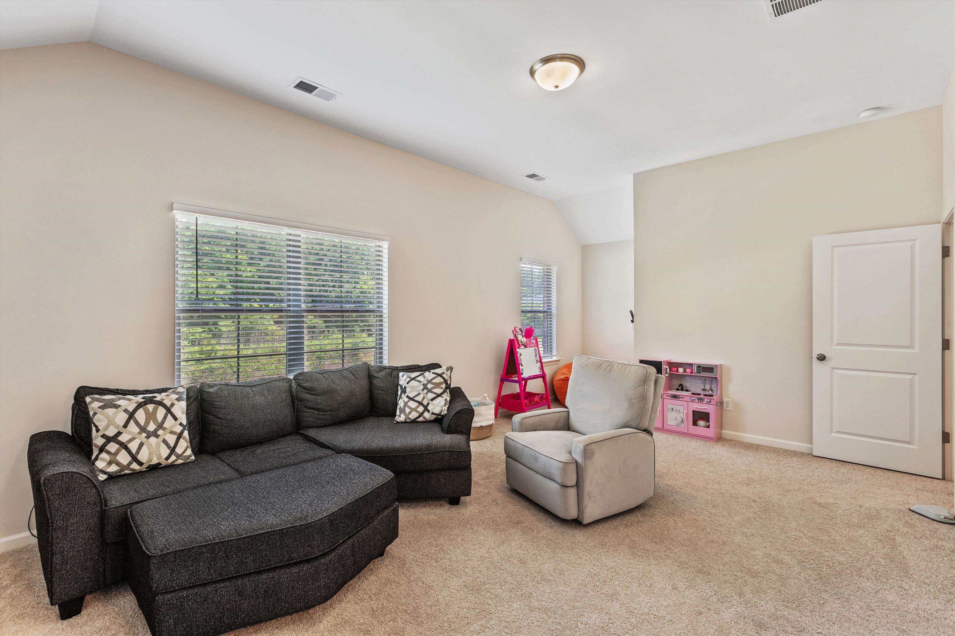 10139 Macon Road Cordova, TN 38018 - Photo 21 of 31 Carpeted room with vaulted ceilings and neutral wall tones