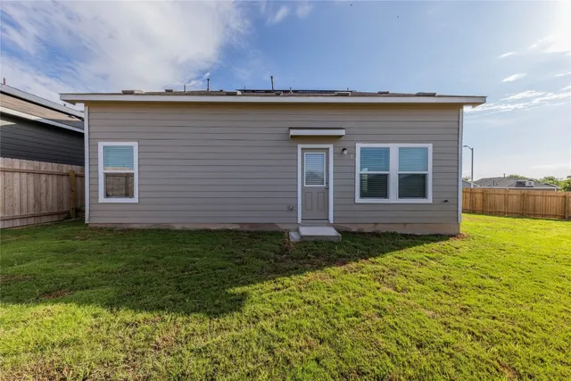 a view of a backyard with plants and a garden