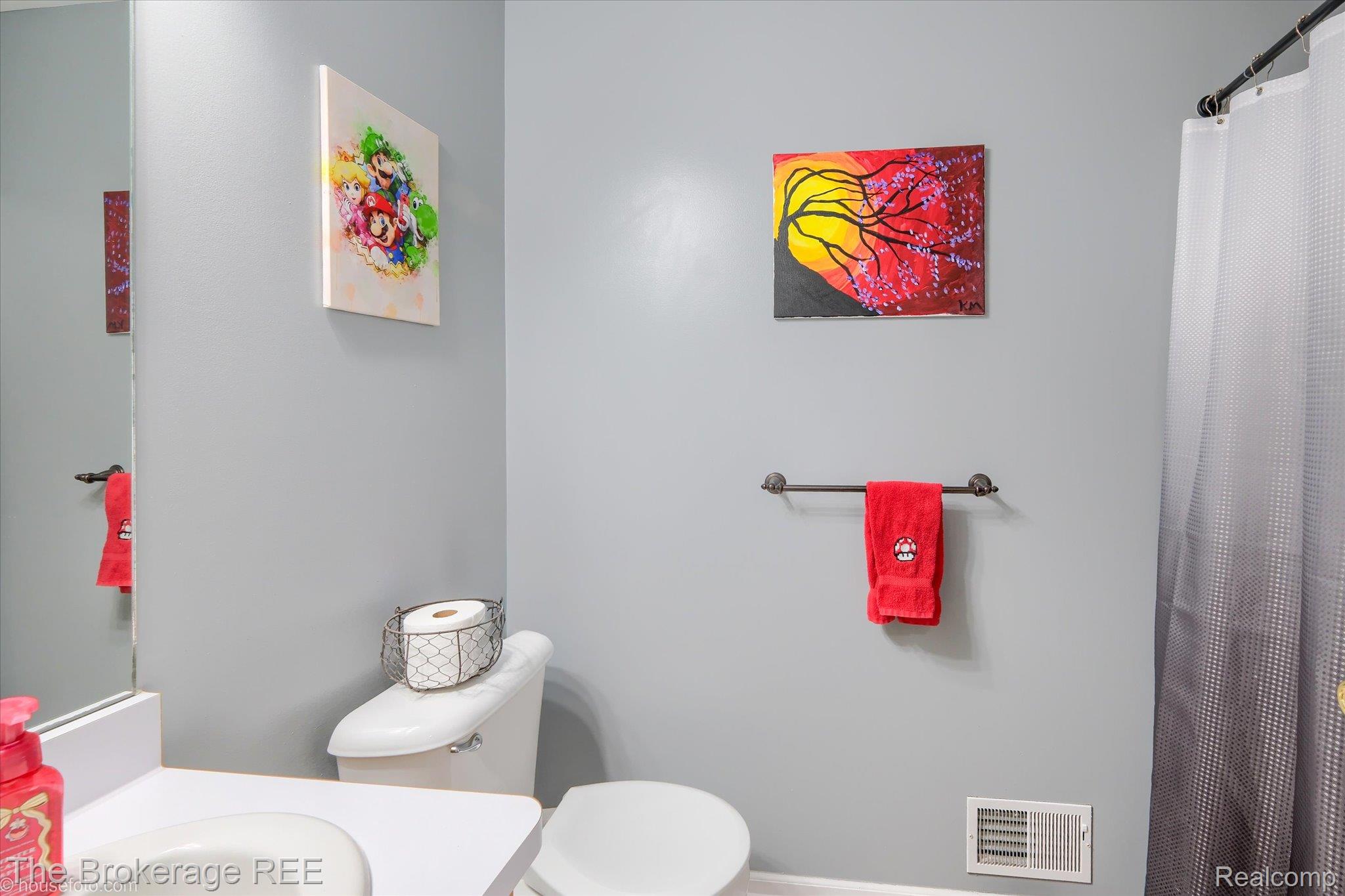 4432 North Belsay Road Flint, MI 48506 - Photo 56 of 79 Bathroom featuring a white toilet, white vanity with integrated sink, and a dark metal towel bar