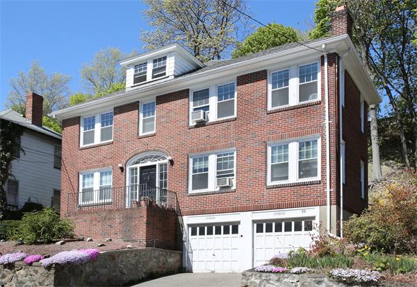 99 Westbourne Terrace, Unit 2 Brookline, MA 02446 - Photo 1 of 6 a front view of a house with a yard