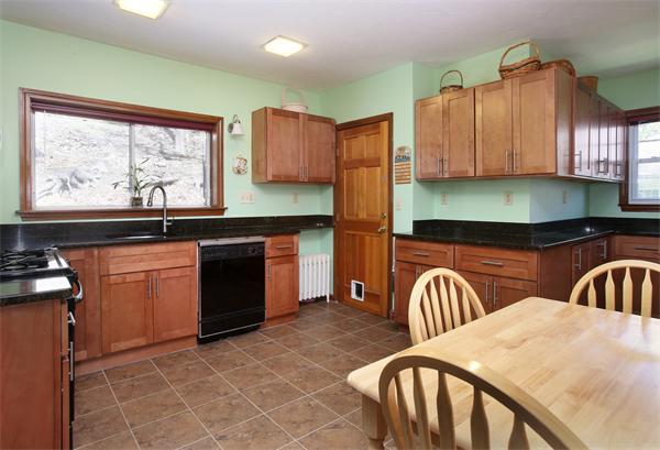 99 Westbourne Terrace, Unit 2 Brookline, MA 02446 - Photo 4 of 6 a kitchen with a sink cabinets and window