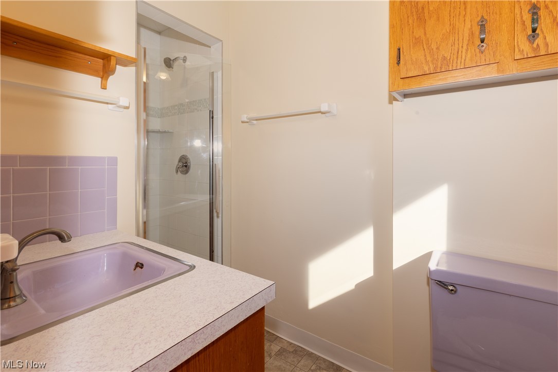 303 North Medina Line Road Akron, OH 44333 - Photo 20 of 30 Bathroom featuring walk in shower, vanity, tile floors, and toilet