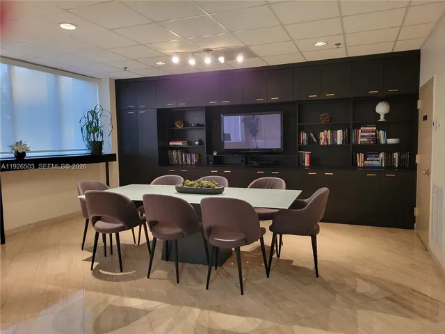 a view of a room with a table and chairs