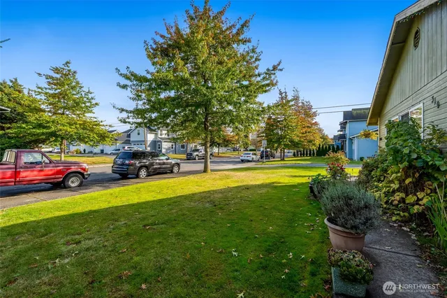 a view of yard with swimming pool and green space